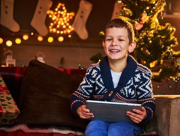 happy-smiling-boy-holds-laptop-gift-on-christmas-2022.jpg