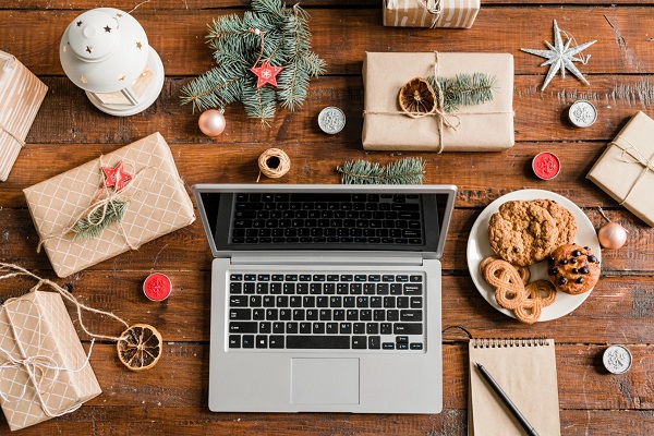 laptop-on-wooden-table-surrounded-by-gifts-cookie-2022.jpg