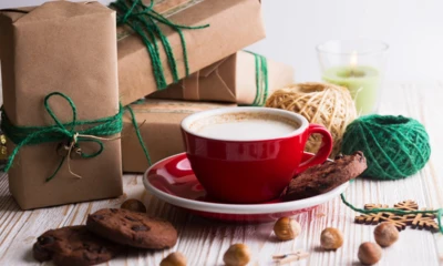 festive-mood-gifts-cup-cappuccino-christmas-decor-wooden-background_522472-2490