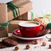 festive-mood-gifts-cup-cappuccino-christmas-decor-wooden-background_522472-2490